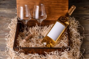 Box with bottle of wine and two glasses
